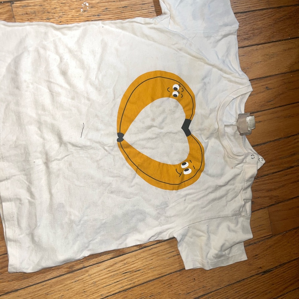 White T-Shirt with Yellow Pretzel Design